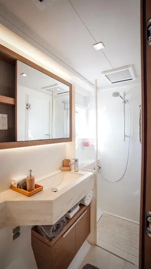 Karma Yacht Photos Pics Modern bathroom interior on 2020 Lagoon 50 yacht, featuring sleek design and shower area.