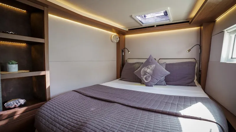 Karma Yacht Photos Pics Cozy bedroom in 2020 Lagoon 50 yacht with modern decor and natural lighting.