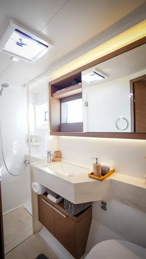 Karma Yacht Photos Pics Modern bathroom interior in 2020 Lagoon 50 yacht, featuring sleek design and ample lighting.