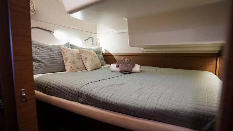 Karma Yacht Photos Pics Cozy bedroom in 2020 Lagoon 50 yacht with elegant bedding and soft lighting.