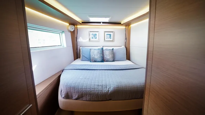 Karma Yacht Photos Pics Luxurious cabin interior of 2020 Lagoon 50 yacht with cozy bed and modern decor.