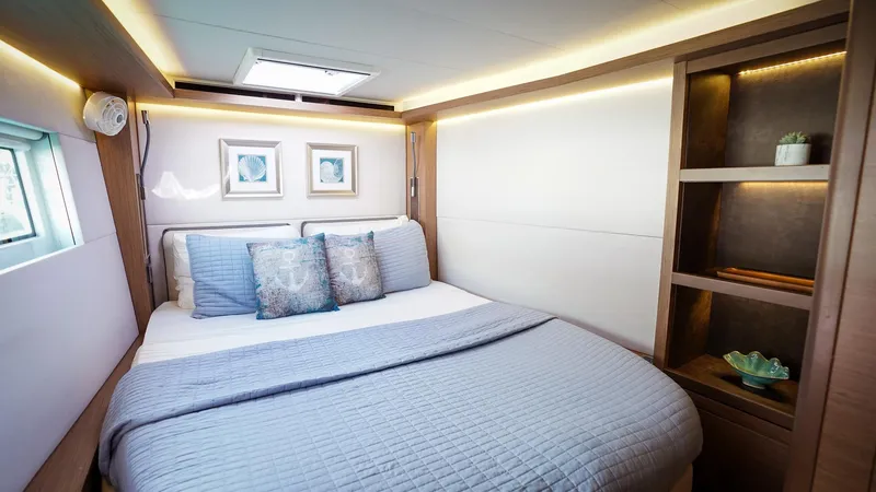 Karma Yacht Photos Pics Luxurious bedroom interior of 2020 Lagoon 50 yacht with modern decor and soft lighting.