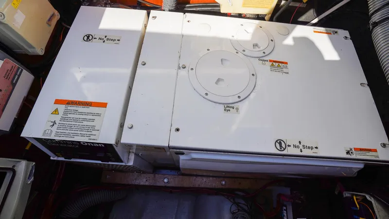 Karma Yacht Photos Pics Engine compartment of a 2020 Lagoon 50 catamaran with safety warnings visible.