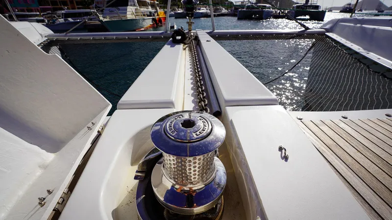Karma Yacht Photos Pics Bow of 2020 Lagoon 50 catamaran with anchor chain and winch in marina.