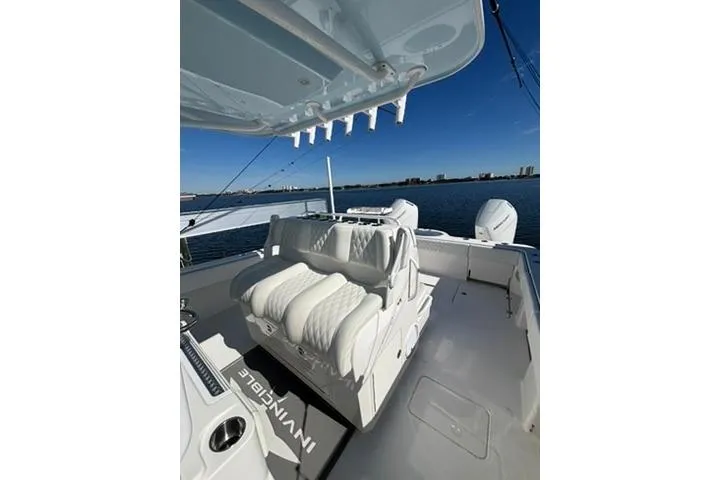  Yacht Photos Pics 2021 Invincible 35 Catamaran with luxurious seating, docked on a sunny day.