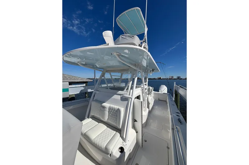  Yacht Photos Pics 2021 Invincible 35 Catamaran with sleek design, docked by the water under a clear blue sky.