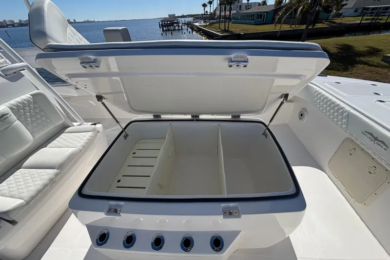  Yacht Photos Pics Open storage compartment on 2021 Invincible 35 Catamaran, featuring sleek seating and waterfront view.