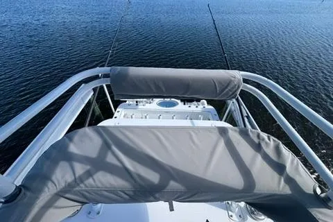  Yacht Photos Pics 2021 Invincible 35 Catamaran helm view with fishing rods on calm water.