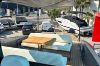 Luxurious 2025 Solaris Power 40F open yacht with elegant seating and table, docked near other boats.