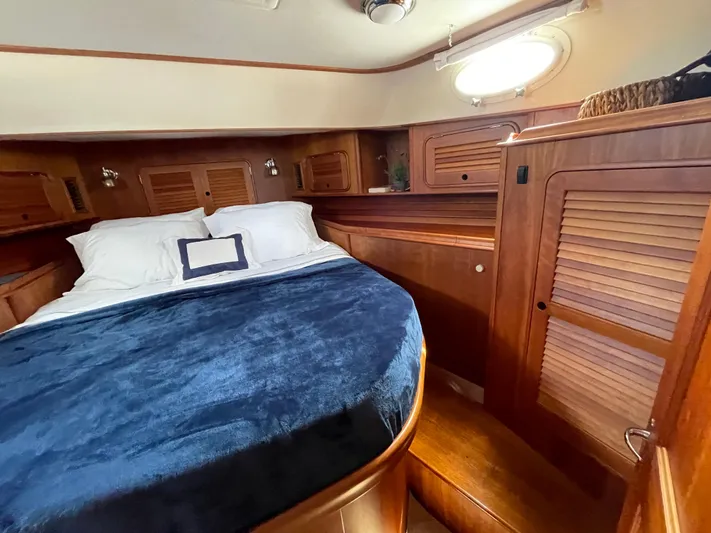 VII Yacht Photos Pics Luxurious cabin interior of 2007 Hinckley Talaria 44 Flybridge with wood finish and cozy bedding.