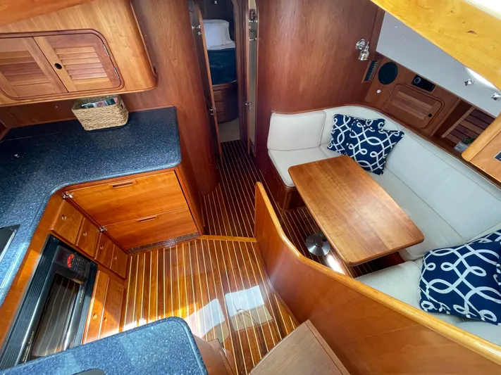 VII Yacht Photos Pics Luxurious 2007 Hinckley Talaria 44 Flybridge interior with elegant wood finish and cozy seating.