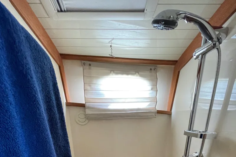 VII Yacht Photos Pics Shower area in 2007 Hinckley Talaria 44 Flybridge with blue towel and window.