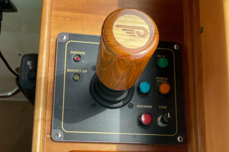 VII Yacht Photos Pics Control panel of a 2007 Hinckley Talaria 44 Flybridge with wooden joystick and buttons.