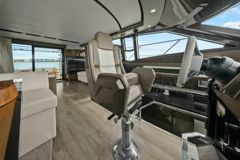 7th Heaven Yacht Photos Pics Luxurious interior of 2014 Marquis 630 Sport Yacht with modern helm and panoramic windows.