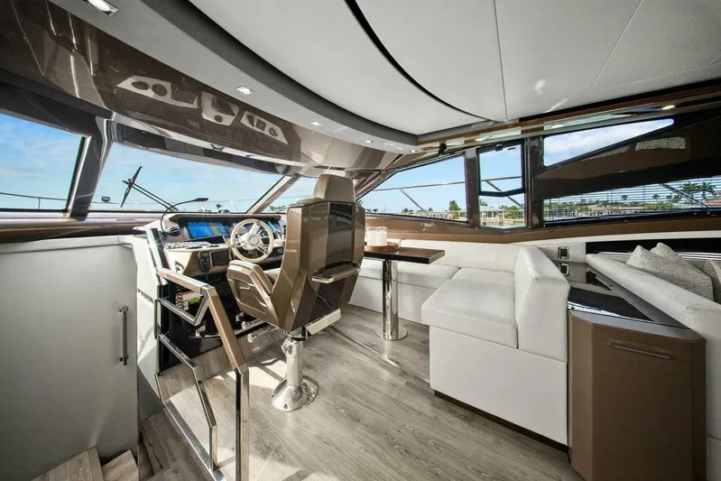 7th Heaven Yacht Photos Pics Luxurious interior of 2014 Marquis 630 Sport Yacht with modern helm and seating area.