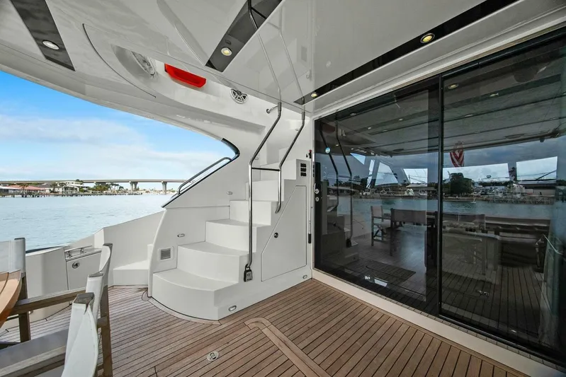 7th Heaven Yacht Photos Pics Luxurious 2014 Marquis 630 Sport Yacht deck with elegant seating and scenic water view.