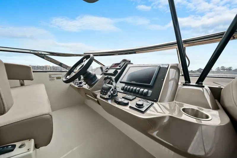 7th Heaven Yacht Photos Pics Helm of 2014 Marquis 630 Sport Yacht with modern controls and navigation system.