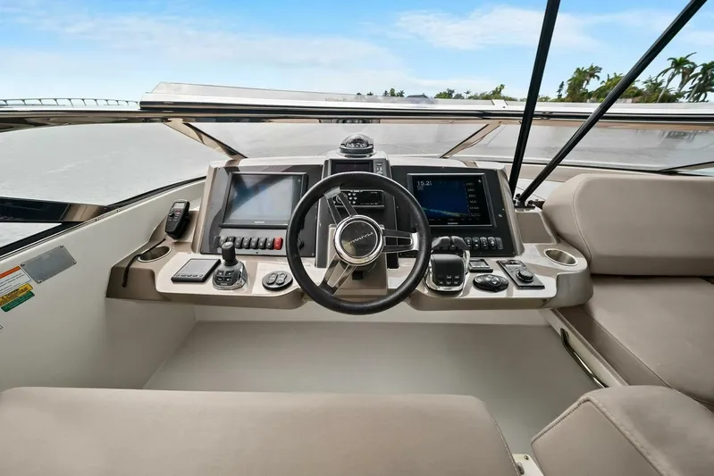 7th Heaven Yacht Photos Pics Helm of 2014 Marquis 630 Sport Yacht with modern navigation controls and displays.
