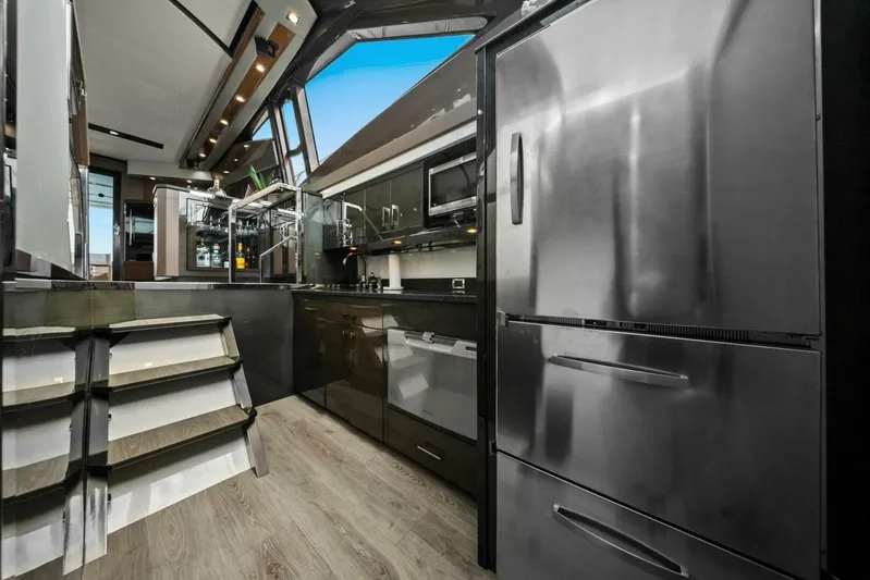 7th Heaven Yacht Photos Pics Luxurious kitchen interior of 2014 Marquis 630 Sport Yacht with modern appliances and sleek design.