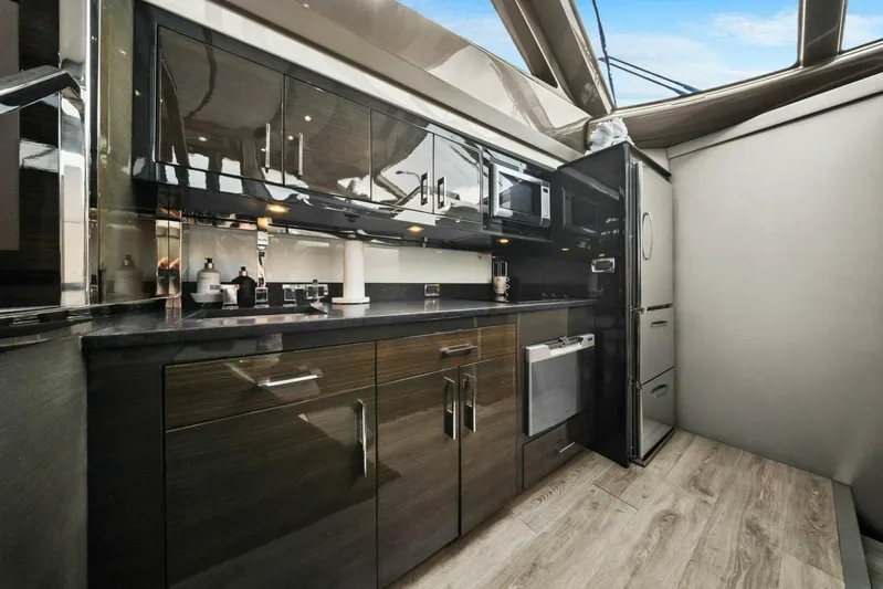 7th Heaven Yacht Photos Pics Luxurious kitchen interior of 2014 Marquis 630 Sport Yacht with modern appliances and sleek cabinetry.