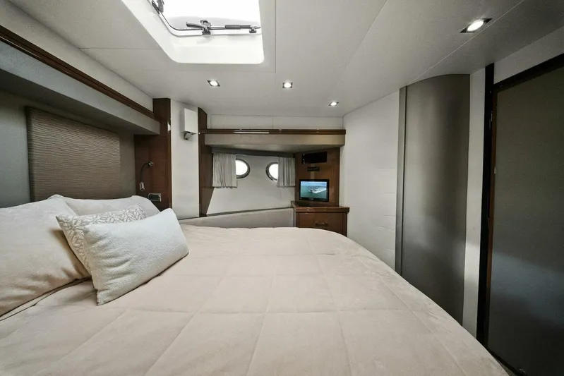 7th Heaven Yacht Photos Pics Luxurious bedroom interior of 2014 Marquis 630 Sport Yacht with cozy bedding and porthole windows.