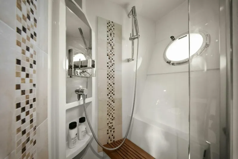 7th Heaven Yacht Photos Pics Luxurious shower in 2014 Marquis 630 Sport Yacht with modern fixtures and porthole window.