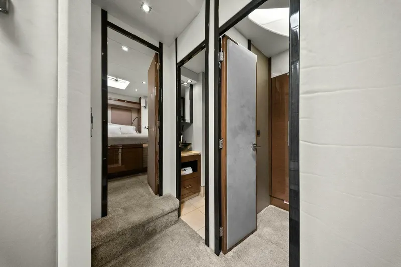 7th Heaven Yacht Photos Pics Interior view of 2014 Marquis 630 Sport Yacht, featuring a hallway with bedroom and bathroom access.