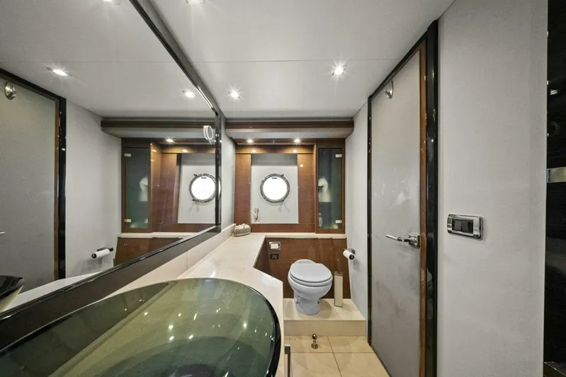 7th Heaven Yacht Photos Pics Luxurious bathroom in 2014 Marquis 630 Sport Yacht with modern fixtures and porthole windows.
