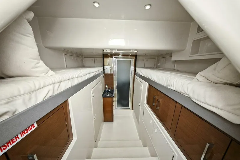 7th Heaven Yacht Photos Pics Interior of 2014 Marquis 630 Sport Yacht with twin bunk beds and modern cabinetry.