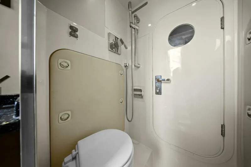 7th Heaven Yacht Photos Pics Bathroom interior of 2014 Marquis 630 Sport Yacht with shower and porthole door.