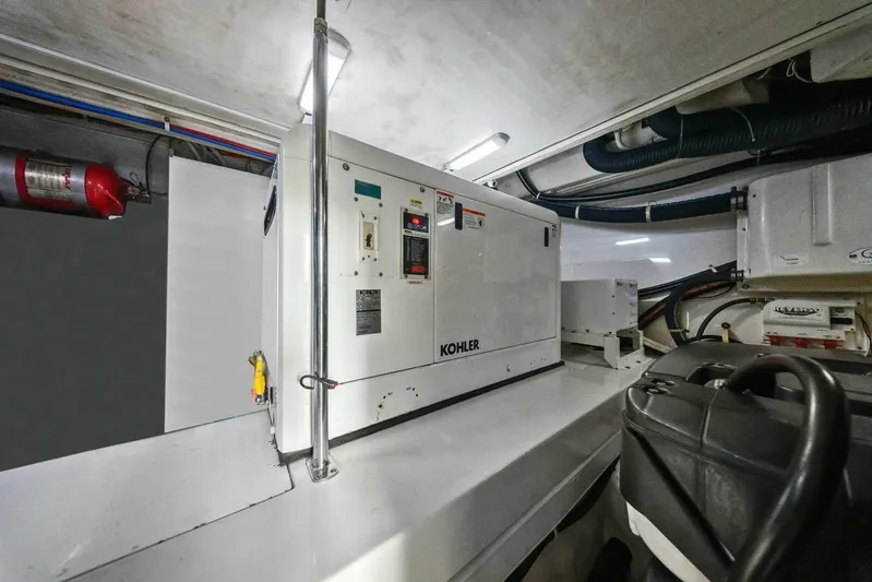 7th Heaven Yacht Photos Pics Engine room of 2014 Marquis 630 Sport Yacht with Kohler generator and fire extinguisher.