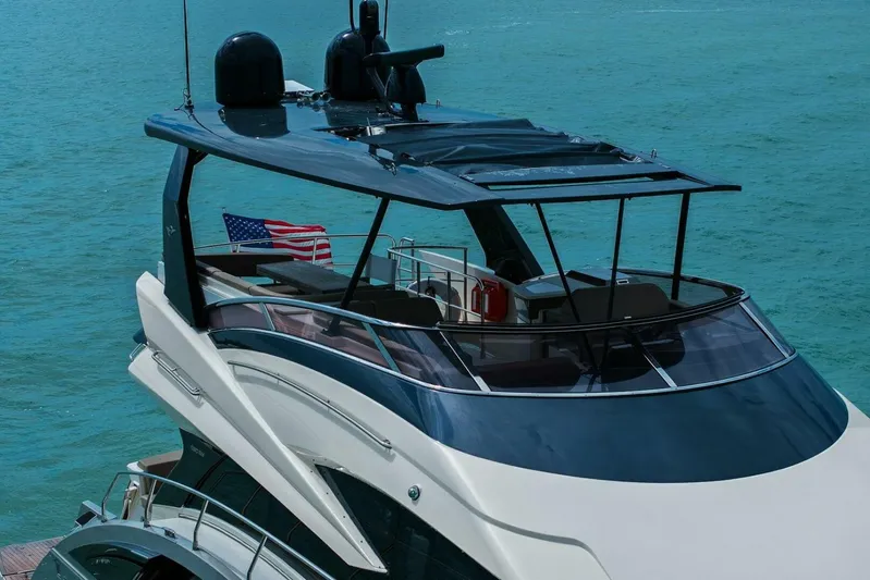 7th Heaven Yacht Photos Pics 2014 Marquis 630 Sport Yacht on blue ocean with American flag.
