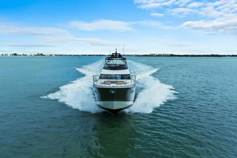 7th Heaven Yacht Photos Pics 2014 Marquis 630 Sport Yacht cruising on open water under a clear blue sky.