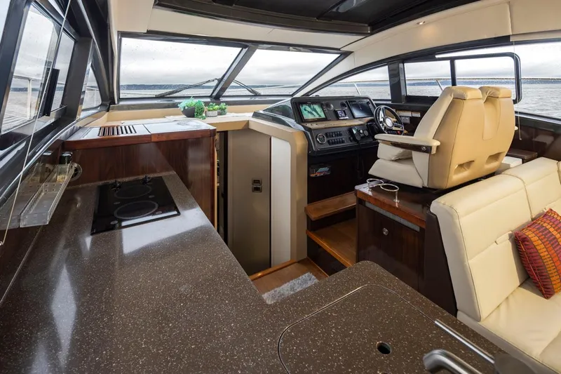 You Betcha Yacht Photos Pics Interior of 2016 Sea Ray 400 Sundancer yacht with modern helm and kitchen area.