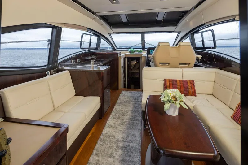 You Betcha Yacht Photos Pics Luxurious interior of 2016 Sea Ray 400 Sundancer yacht with elegant seating and panoramic windows.