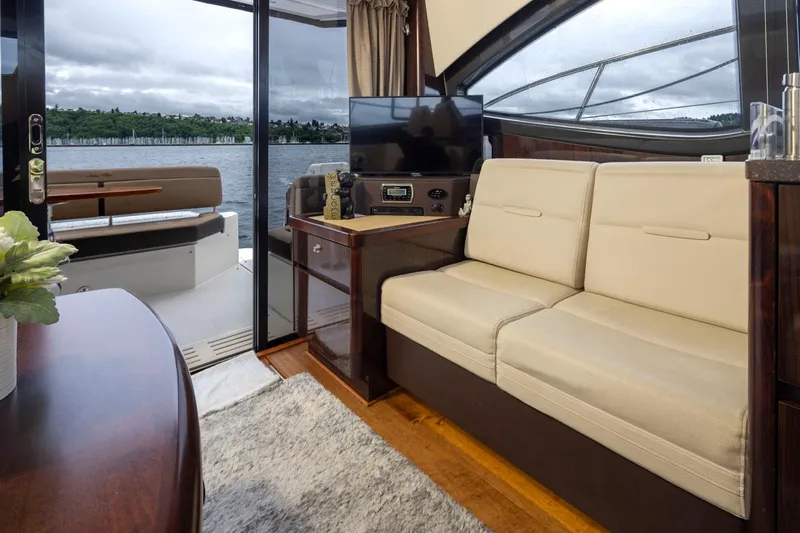 You Betcha Yacht Photos Pics Interior of 2016 Sea Ray 400 Sundancer yacht with beige seating and lake view.