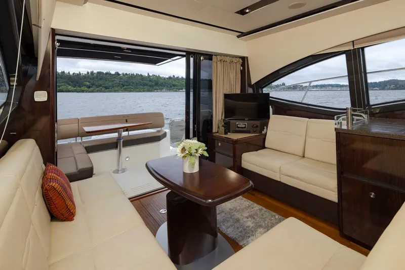 You Betcha Yacht Photos Pics Luxurious interior of 2016 Sea Ray 400 Sundancer yacht with elegant seating and scenic water view.