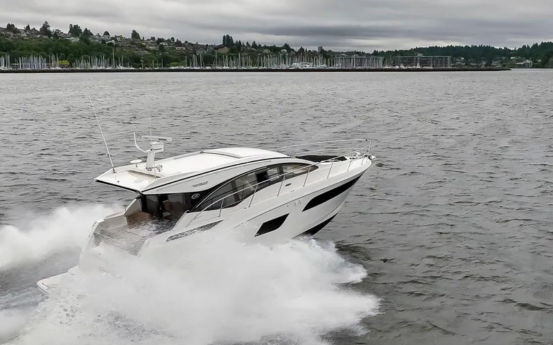 You Betcha Yacht Photos Pics 2016 Sea Ray 400 Sundancer cruising on a lake with a scenic shoreline backdrop.