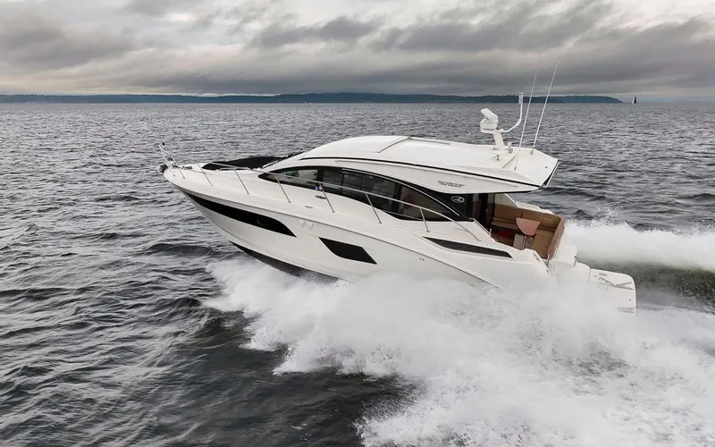 You Betcha Yacht Photos Pics 2016 Sea Ray 400 Sundancer cruising on open water under cloudy skies.