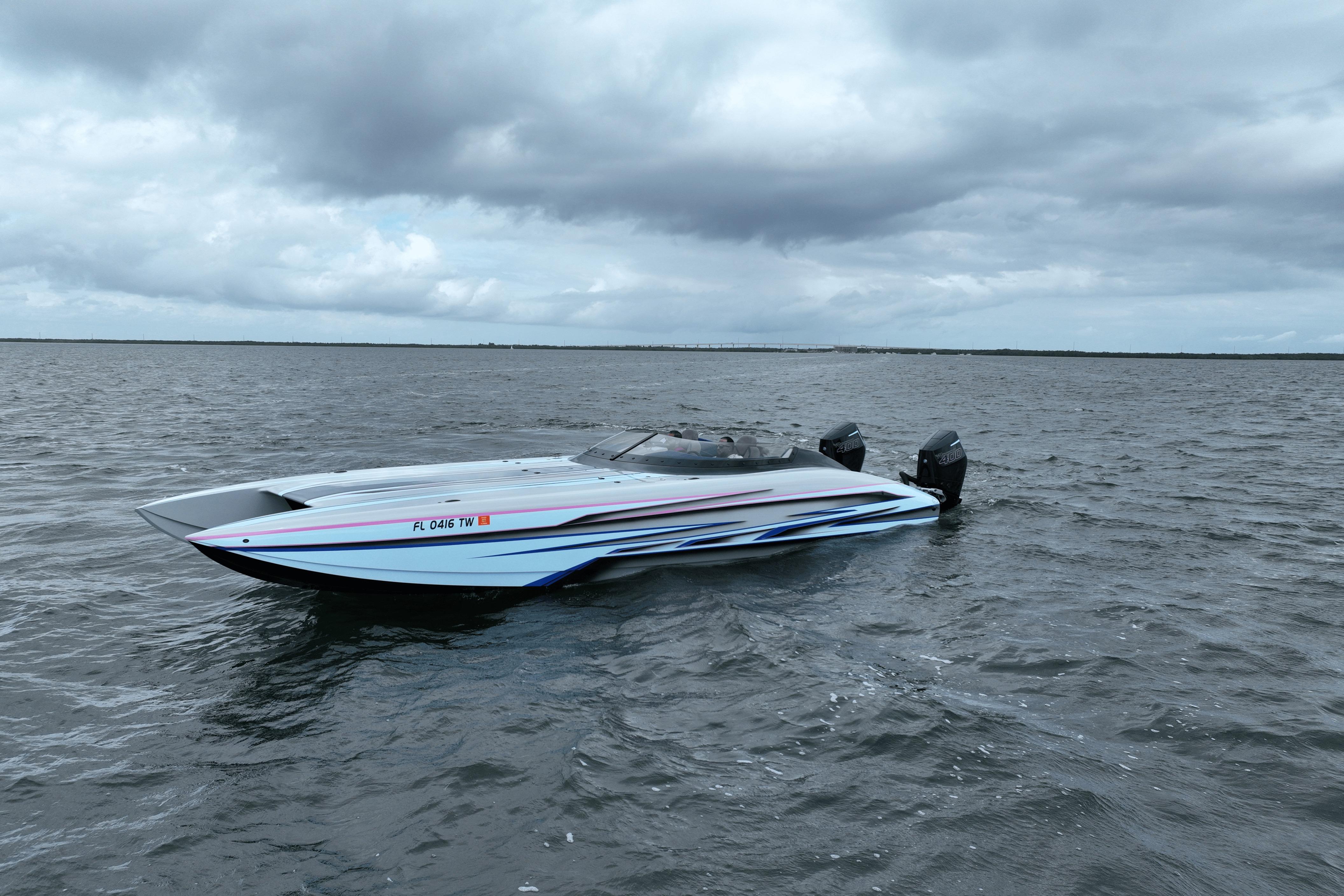 2024 Dug Wright 32 speedboat on open water under cloudy skies.