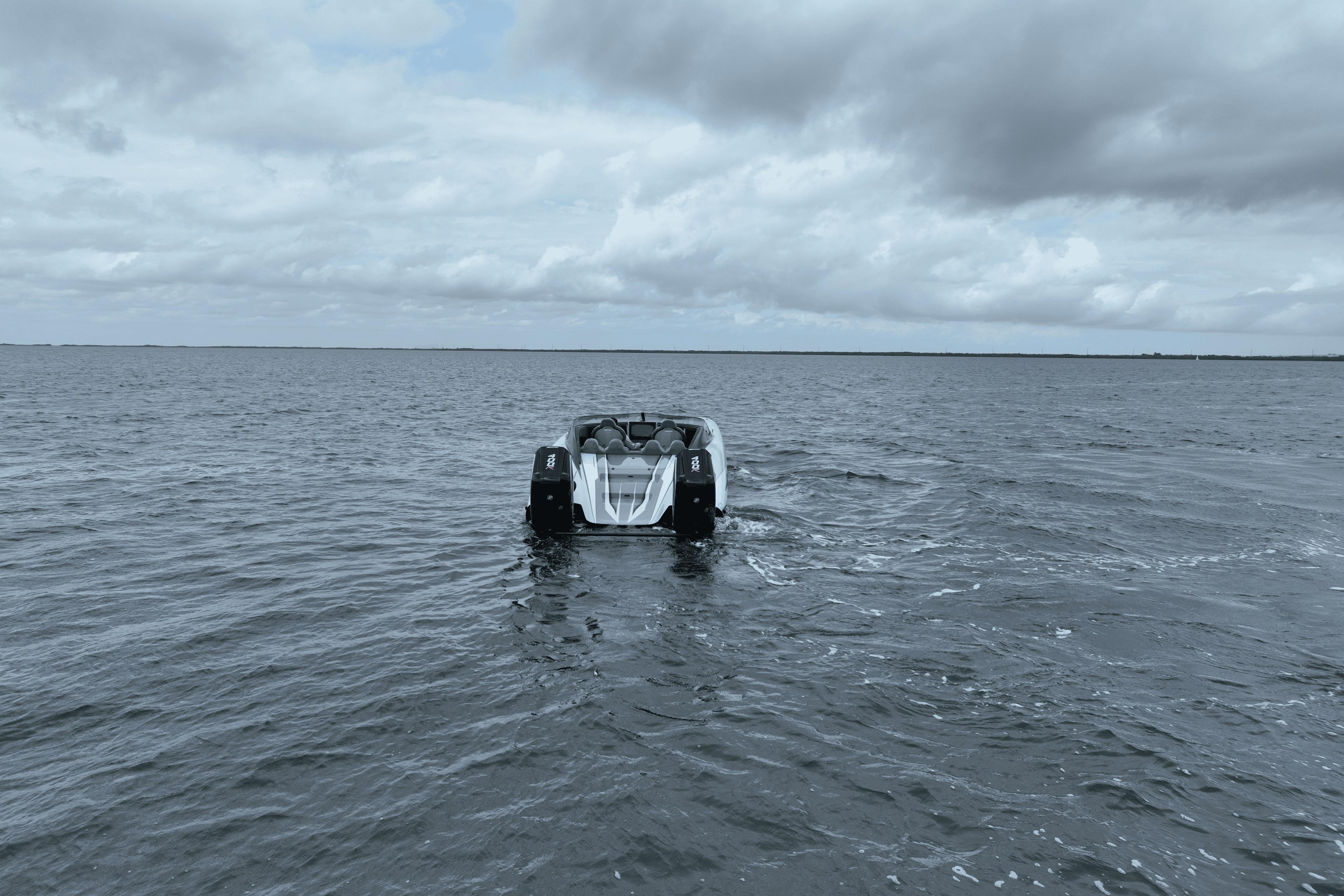 2024 Dug Wright 32 boat cruising on open water under cloudy skies.