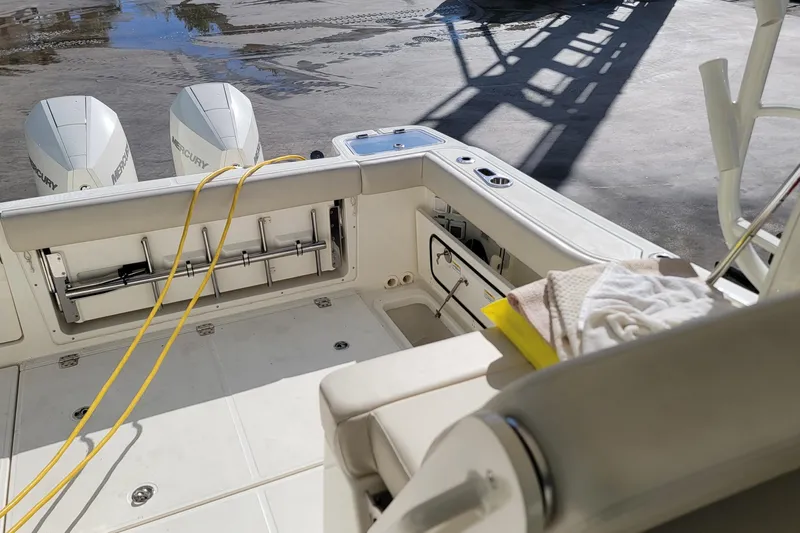  Yacht Photos Pics 2023 Boston Whaler 325 Conquest boat interior with dual Mercury engines and seating area.