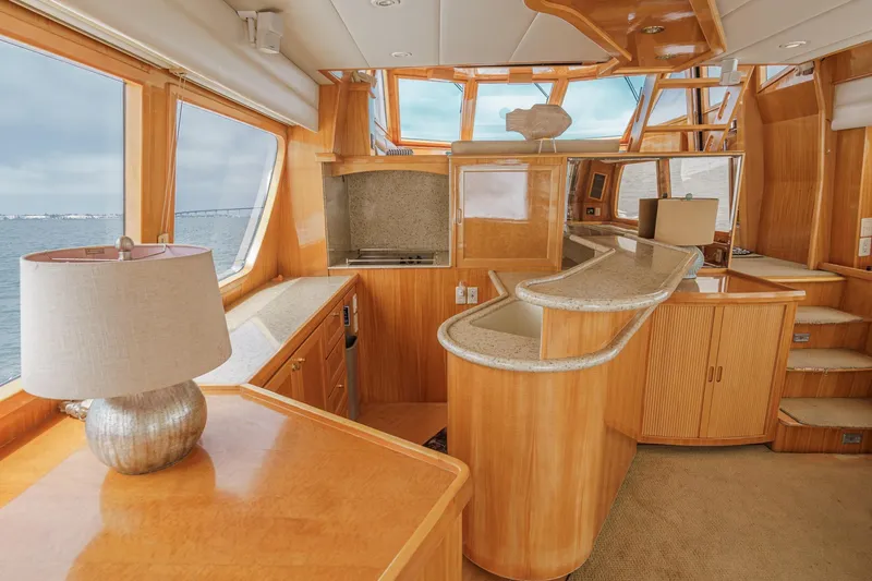 Sweet Seas Yacht Photos Pics Luxurious interior of 2001 McKinna 57 Pilothouse yacht with elegant wood finishes.