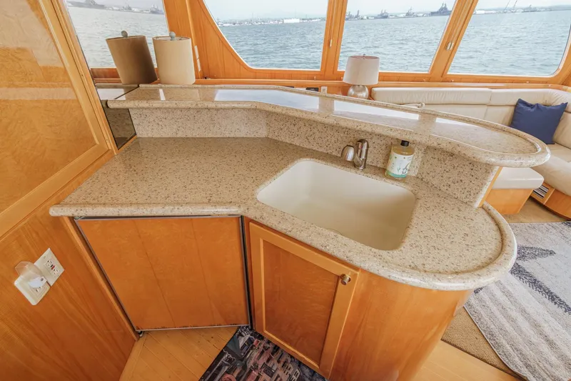 Sweet Seas Yacht Photos Pics Luxurious 2001 McKinna 57 Pilothouse yacht interior with elegant kitchen and ocean view.