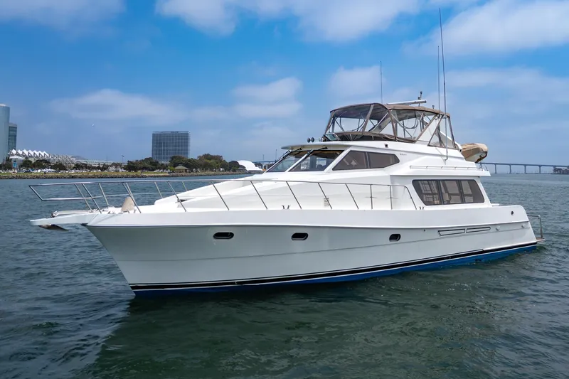 Sweet Seas Yacht Photos Pics 2001 McKinna 57 Pilothouse yacht cruising on a sunny day near city skyline.