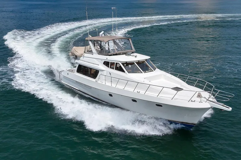 Sweet Seas Yacht Photos Pics 2001 McKinna 57 Pilothouse yacht cruising on open water, creating a dynamic wake.