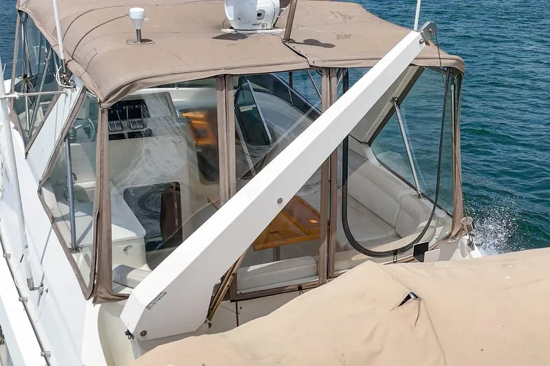 Sweet Seas Yacht Photos Pics 2001 McKinna 57 Pilothouse yacht with beige canopy on blue water.