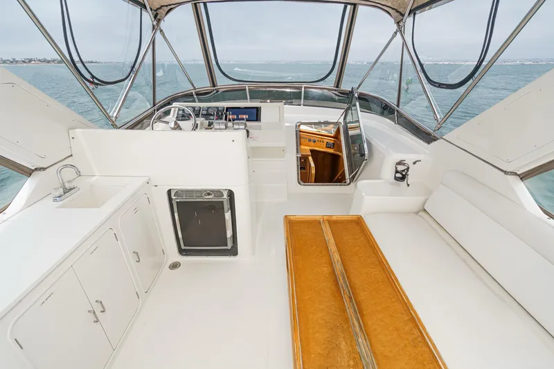 Sweet Seas Yacht Photos Pics 2001 McKinna 57 Pilothouse yacht interior with helm, seating, and kitchenette on open water.