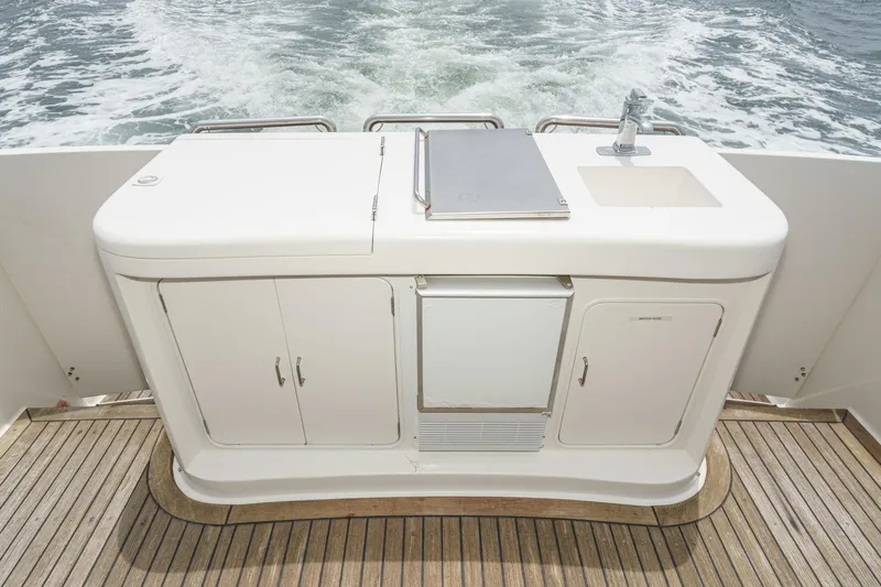 Sweet Seas Yacht Photos Pics Outdoor kitchen on 2001 McKinna 57 Pilothouse yacht, featuring sink and storage.