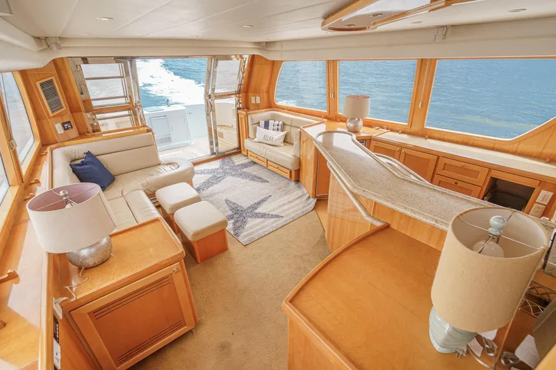 Sweet Seas Yacht Photos Pics Luxurious interior of 2001 McKinna 57 Pilothouse yacht with elegant seating and ocean view.
